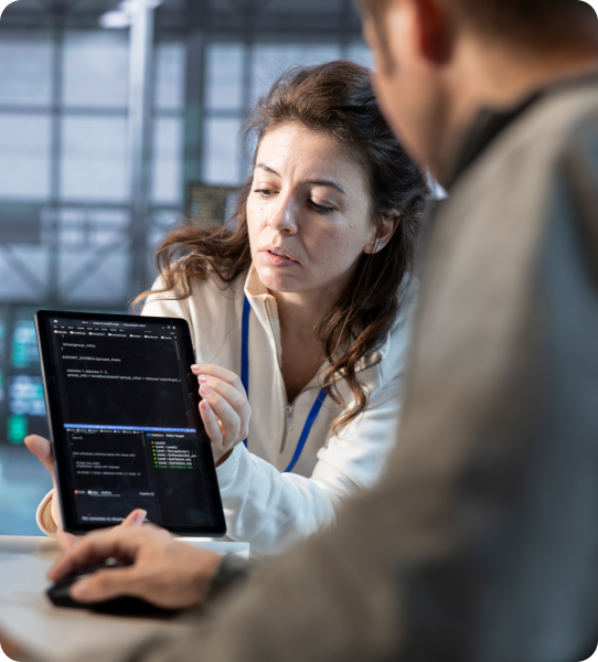 Professionals reviewing cloud infrastructure code on a tablet