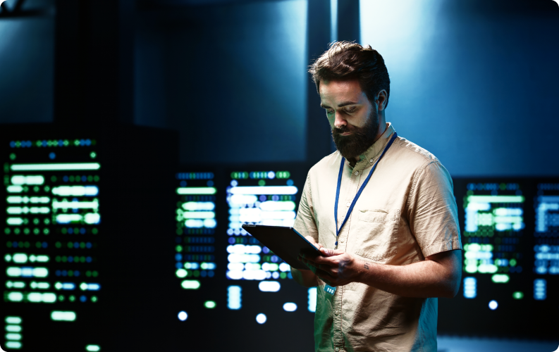 Engineer monitoring servers on a tablet in a data center
